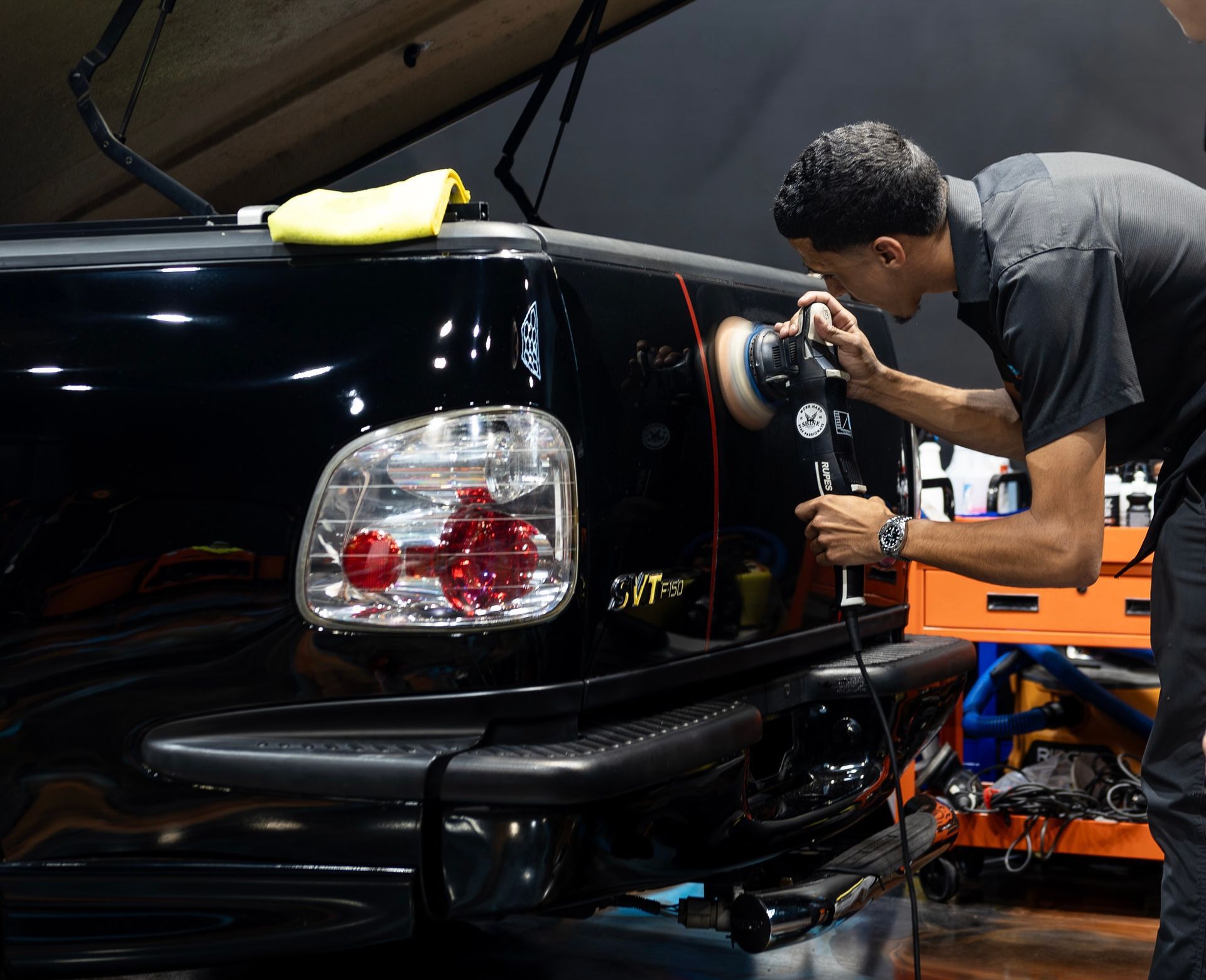 Technician machine polishing paint before ceramic coating