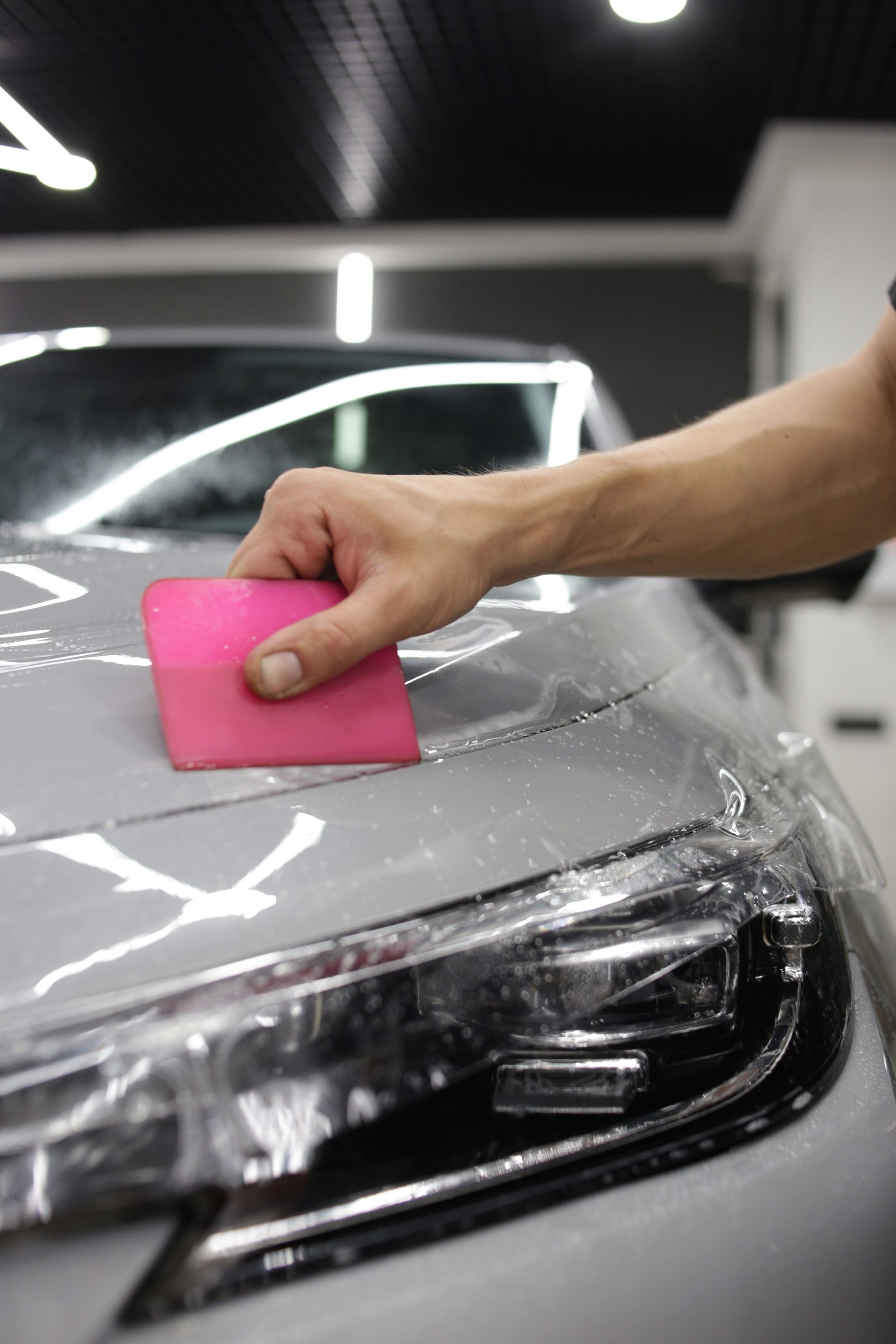 Close-up of paint protection film wrapped around a panel edge